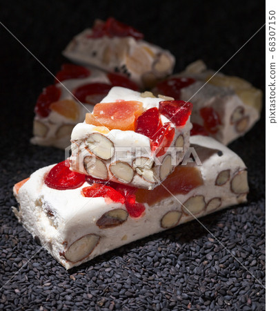 Soft nougat with tropical fruit and berries on a Soft nougat with tropical fruit and berries on a 68307150