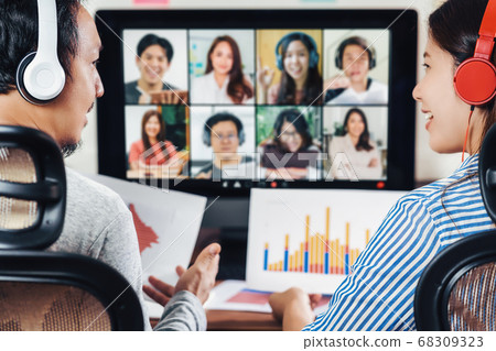 Rear view of Asian partner working and online meeting via video conference with colleague and team building when Covid-19 pandemic,Coronavirus outbreak,education and Social distancing,new normal 68309323