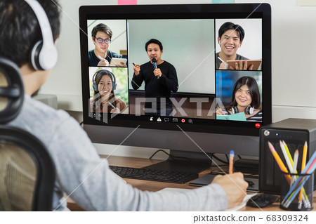 Rear view of Asian businessman working and online meeting via video conference with colleague and team building when Covid-19 pandemic,Coronavirus outbreak,Social distancing and new normal concept 68309324