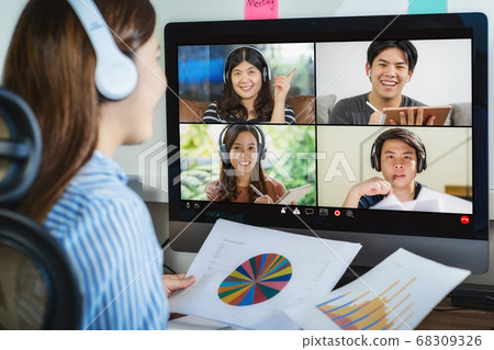 Rear view of Asian businesswoman working and online meeting via video conference with colleague and team building when Covid-19 pandemic,Coronavirus outbreak,education and Social distancing,new normal 68309326