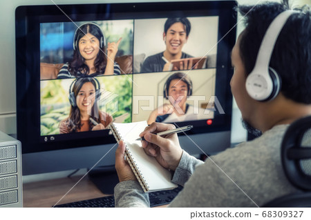 Closeup Asian man hand writing notebook when online learning via video conference with colleague and team building meeting when Covid-19 pandemic,Coronavirus outbreak,online meeting,new normal concept 68309327