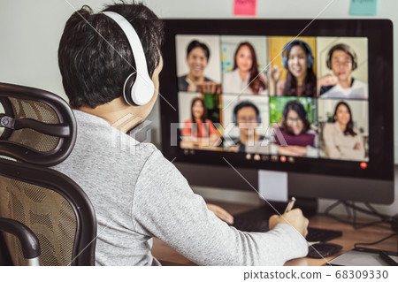 Rear view of Asian man working and online meeting via video conference with colleague and team building when Covid-19 pandemic, Coronavirus outbreak, education and Social distancing,new normal concept 68309330