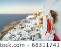 Europe Greece Santorini travel vacation woman on famous santorini Oia island travel destination. Happy young tourist woman. Summer wanderlust. 68311741