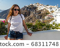 Happy smiling woman tourist traveling on luxury cruise in Mediterranean, Greece, Santorini. Background architecture island sea sky 68311748