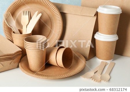 Eco - friendly tableware and paper bag on wooden 68312174