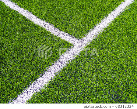 White line on the green grass on soccer field football 68312324