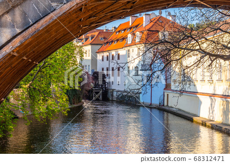 Old water mill wheel under the Charles Bridge, Certovka River, Prague, Czech Republic 68312471