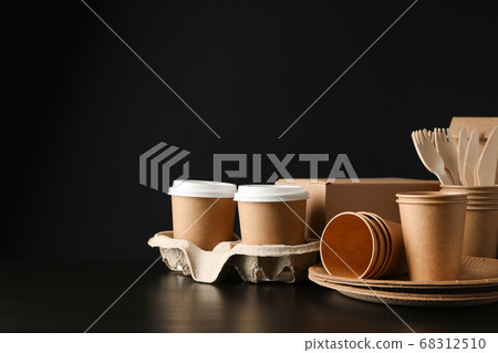 Eco - friendly dishware and carton box on black 68312510