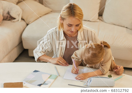 Young Mother Homeschooling Little Girl 68312792