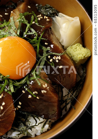 Pickled bonito with chopped seaweed, large leaves, gari, wasabi and egg yolk on the center (black background, bird's eye view) 68313095