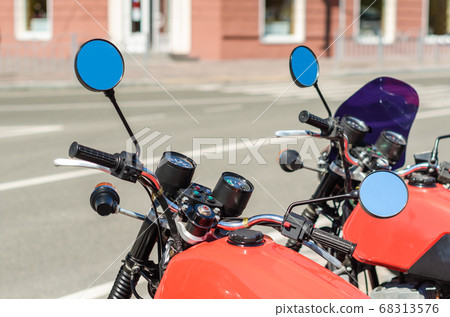 two red vintage motorcycle cafe racer on a city two red vintage motorcycle cafe racer on a city 68313576