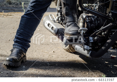 foot bikers in motorcycle boots sitting on a motorcycle foot bikers in motorcycle boots sitting on a motorcycle 68313597