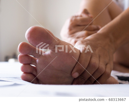 Young asian woman massaging on feet to relax Young asian woman massaging on feet to relax 68313667