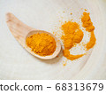 Yellow turmeric powder in wooden spoon 68313679