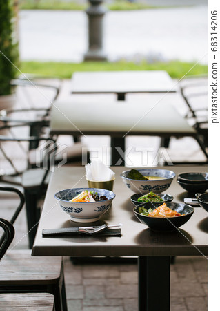 Dark table served with asian style japanese dishes 68314206