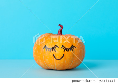 Pumpkin with smile on blue background, space for 68314331