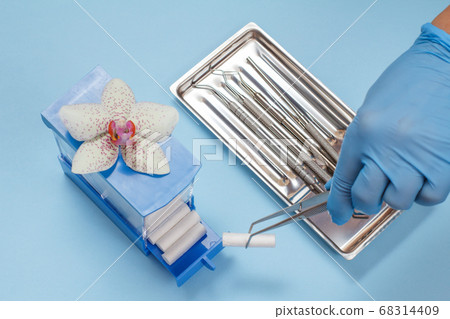Dentist's hand with set of metal dental 68314409
