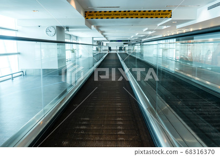A travelator in an empty airport corridor during A travelator in an empty airport corridor during 68316370