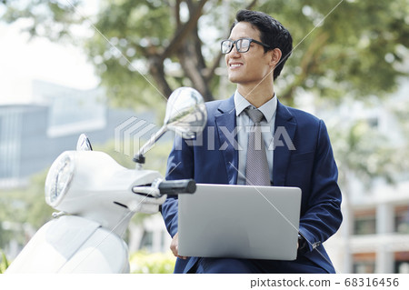 Business executive working on laptop Business executive working on laptop 68316456
