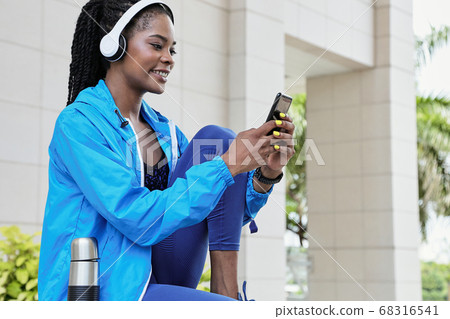 Woman checking workout mobile app 68316541