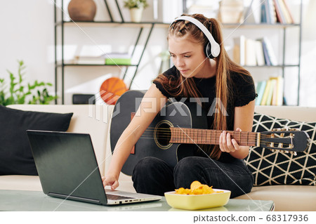 Teenage girl writing new song 68317936