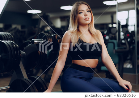 Portrait of a fit young blonde woman in black sport bra 68320510