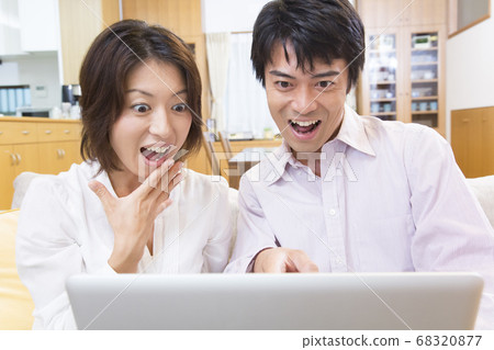 Middle-aged couple looking at a laptop 68320877