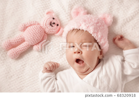 Cute newborn baby girl lying in the bed Cute newborn baby girl lying in the bed 68320918