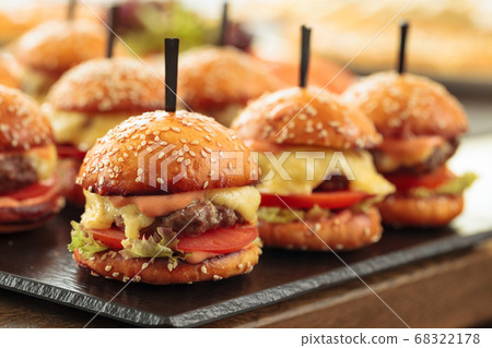 Burgers on wooden table in restaurant . Burgers on wooden table in restaurant . 68322178