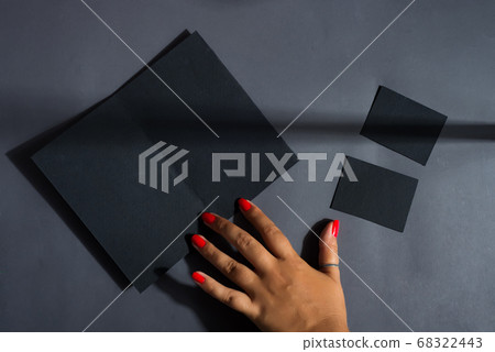 Brochure black mockup card in a woman's hand. Brochure black mockup card in a woman's hand. 68322443
