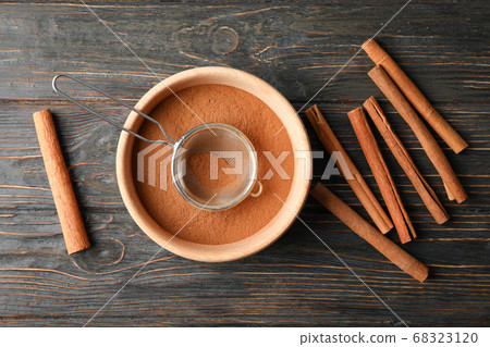 Cinnamon sticks, powder and sieve on wooden Cinnamon sticks, powder and sieve on wooden 68323120