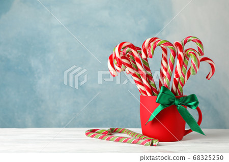 Candy canes in red cup on white wooden background, Candy canes in red cup on white wooden background, 68325250