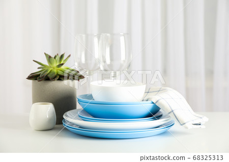 Cutlery with succulent plant stacked on white 68325313