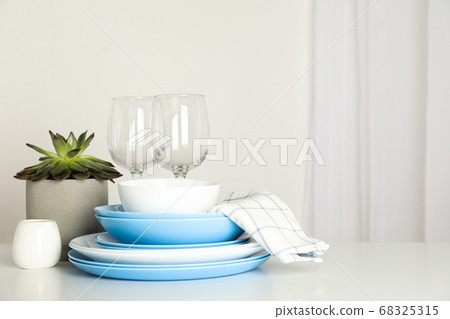 Cutlery with succulent plant stacked on white 68325315