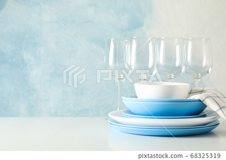 Cutlery beautifully stacked on white table against 68325319