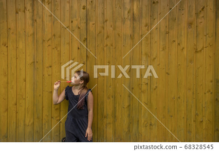 A cute young girl holding a lollipop 68328545
