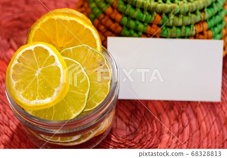 Dried fruits lemon, lime and orange in a glass and small white card for Dried fruits lemon, lime and orange in a glass and small white card for 68328813