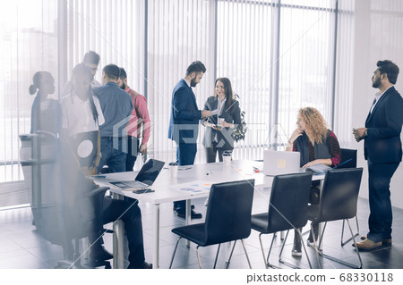 Diverse smiling businesspeople having conversation standing together at meeting. Diverse smiling businesspeople having conversation standing together at meeting. 68330118