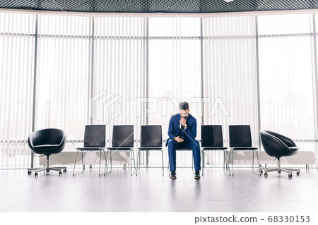 lonely handsome man fashion suit sitting with smartphone lonely handsome man fashion suit sitting with smartphone 68330153