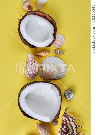 Closeup cracked coconut parts and seashells. 68330345