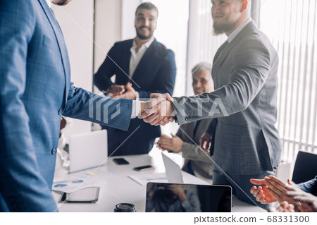 Business people shaking hands, finishing up a meeting Business people shaking hands, finishing up a meeting 68331300