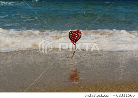 Red Heart Shape with Ribbon on the Beach Red Heart Shape with Ribbon on the Beach 68331560
