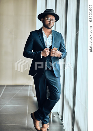 confident good looking rich man with a phone looking at the camera confident good looking rich man with a phone looking at the camera 68331665
