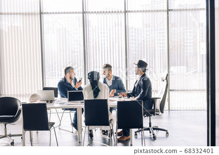 Serious Indian CEO in interacting with multiracial vendors at corporate meeting Serious Indian CEO in interacting with multiracial vendors at corporate meeting 68332401