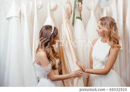 two caucasian girlfriends among wedding dresses two caucasian girlfriends among wedding dresses 68332910