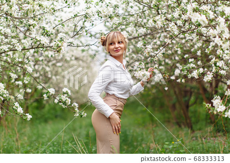 Beautiful young blonde woman in white shirt posing Beautiful young blonde woman in white shirt posing 68333313
