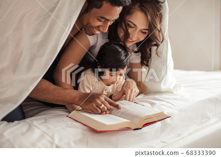 attractive smiling couple getting pleasure from reading attractive smiling couple getting pleasure from reading 68333390