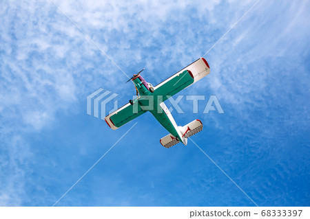 Small single engine vintage colorful airplane in a 68333397
