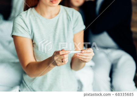 closeup of woman checking thermometer closeup of woman checking thermometer 68335685
