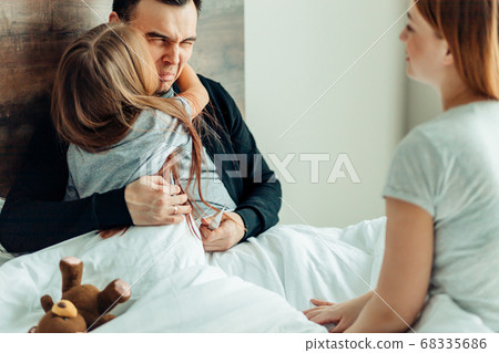 portrait of lovely family on bed at home portrait of lovely family on bed at home 68335686